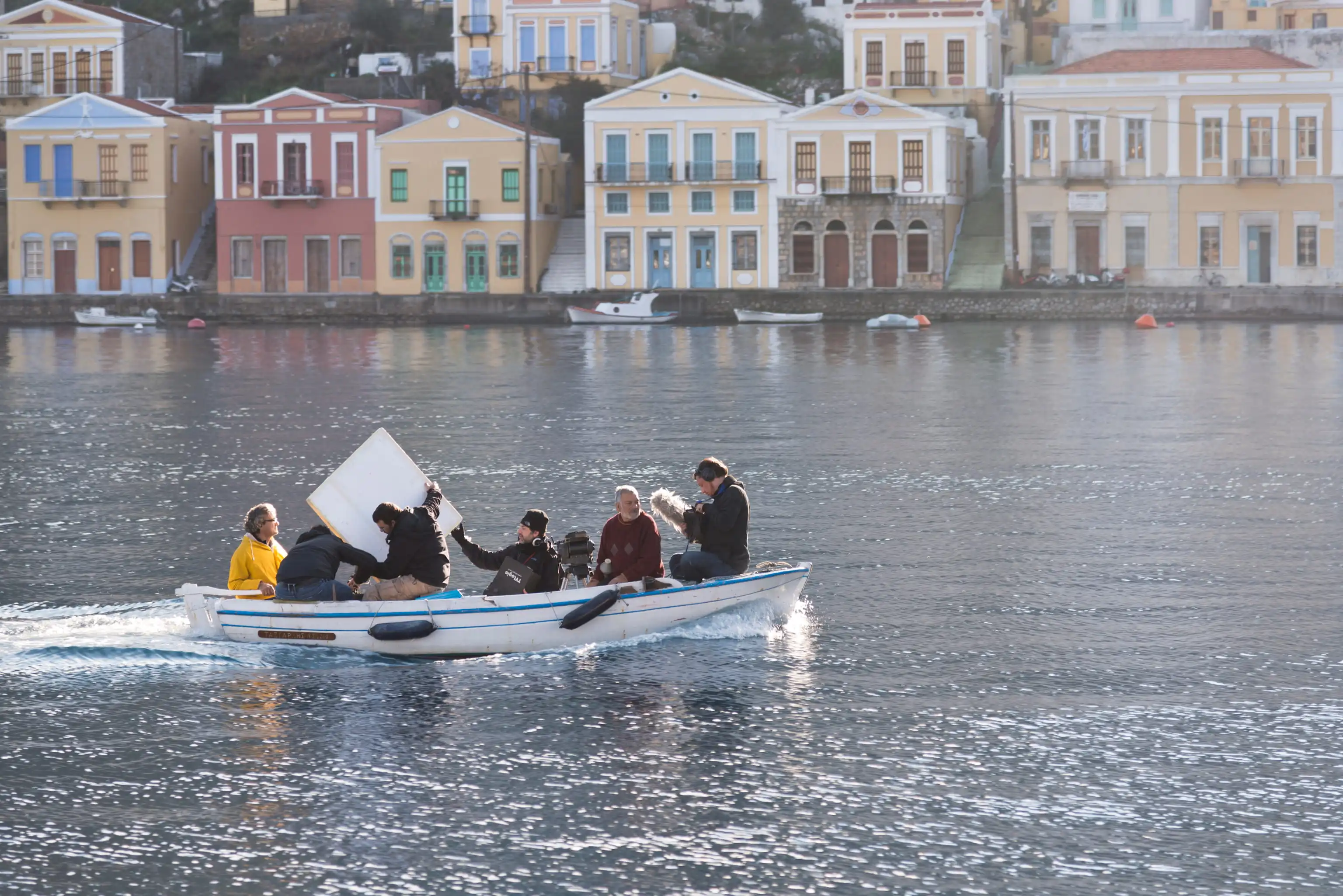 Film crew on a small boat in Symi harbour